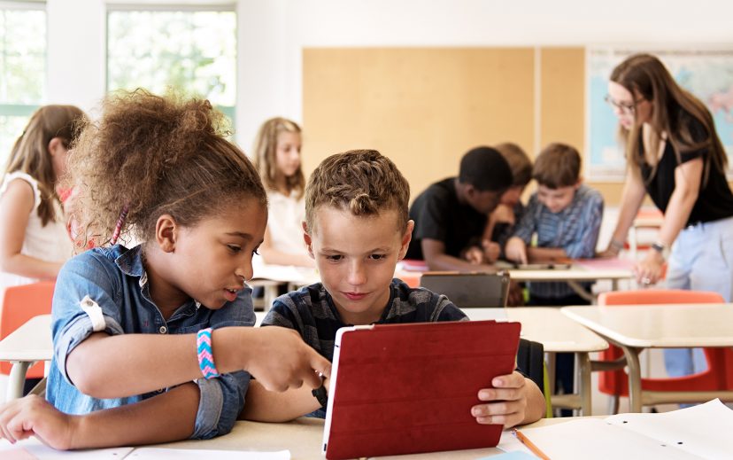 Students using technology to learn in their classroom